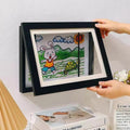 Frame for children's drawings with storage opening